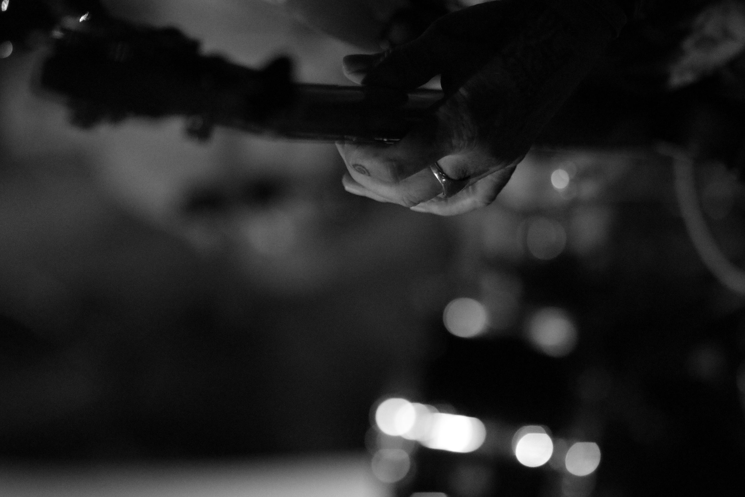 A guitarist's hand on the fretboard, live in Hội An