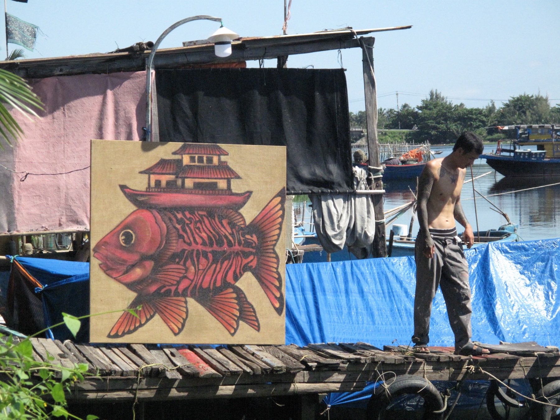 Sơn Nguyễn painting a mural